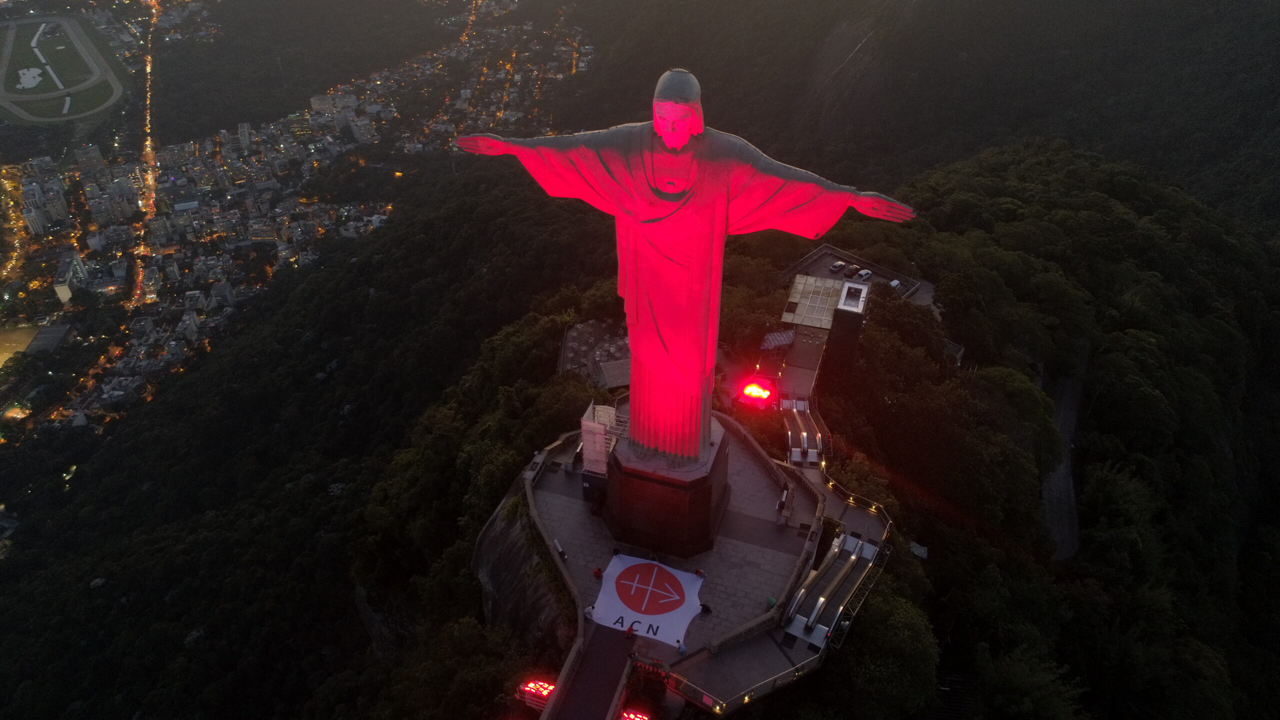 Christ the Redeemer in red light during Red Wednesday 2020
